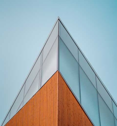 Low-angle-shot-of-an-edge-of-high-rise-modern-building-against-a-blue-sky.jpg